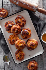 Orange homemade buns on a wooden gray background