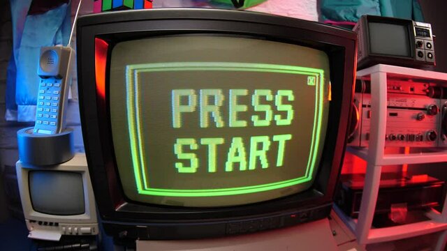 Retro video game concept showing PRESS START message on a computer screen. 80s 90s scene.