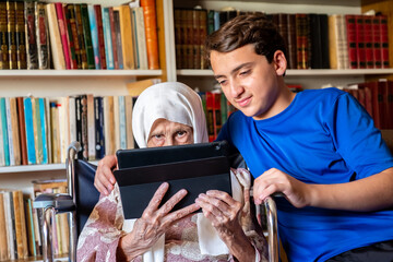 Old woman holding her tablet - Powered by Adobe