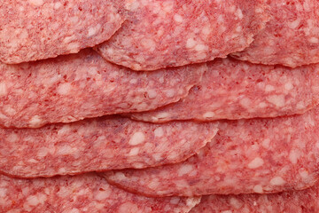Sausage slices filling background. Salami snack slices texture.