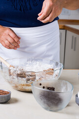 Ingredients for making chocolate cookies, flour sugar, eggs and cocoa are placed on a table