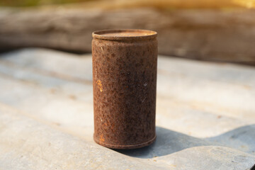 Rusty old cans background light orange