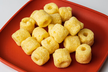 Crispy Corn rings salty snacks. Fast food or junk food snacks unhealthy concept.