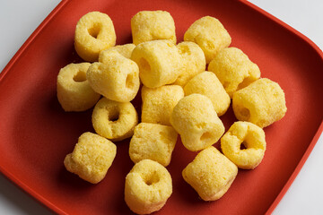 Crispy Corn rings salty snacks. Fast food or junk food snacks unhealthy concept.