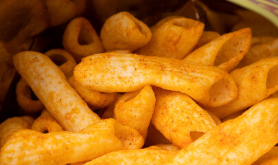 Crispy penne pasta shaped salty. Fast food or junk food snacks unhealthy concept.