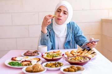 muslim girl is eating her breakfast