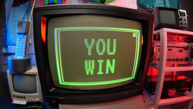 Vintage video game screen showing YOU WIN on an old monitor. 80s 90s concept.