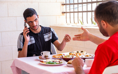 Muslim man and his friend are eating together