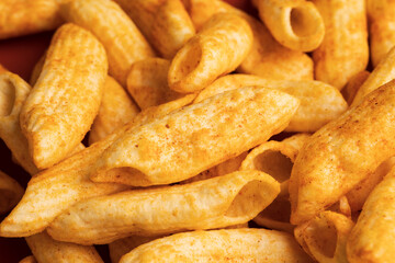 Crispy penne pasta shaped salty. Fast food or junk food snacks unhealthy concept.