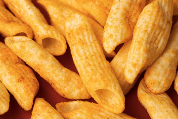 Crispy penne pasta shaped salty. Fast food or junk food snacks unhealthy concept.