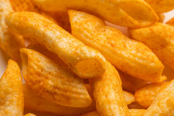 Crispy penne pasta shaped salty. Fast food or junk food snacks unhealthy concept.
