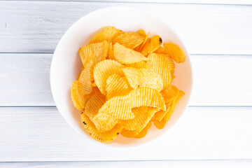 Tasty potatoes chips in bowl