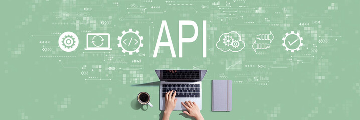 API - application programming interface concept with person working with a laptop