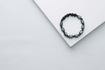 Round natural black stone bracelet on white  background, healthy stone bracelet
