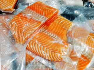 Frozen salmon fillet in plastic packing for sell in supermarket or seafood market. - 417149163