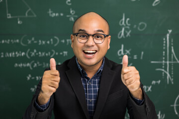 Indian young teacher man looking at camera sitting teaching online video conference live stream. Asian teacher teaching class webinar online for students learning.