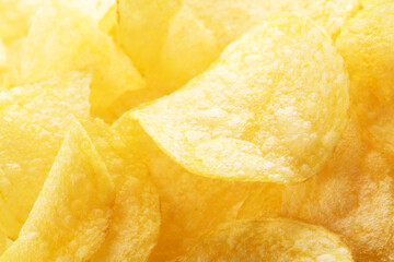 Potato chips pattern. Yellow salted potato chips as food background. Chips texture, studio photo, close up