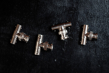 Triple bnc adapter for transmitting video and audio signal on a dark background