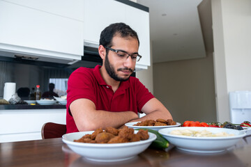 Fototapeta na wymiar Arabic man is eating breakfast