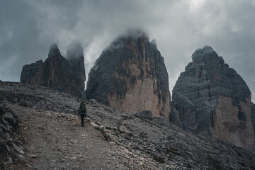 Girl hiking in front of the tre cime di lavaredo in the Dolomites, Italy