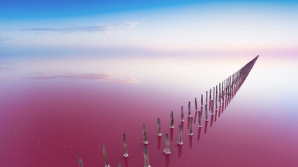 Sunset on a pink lake, orange clouds reflected in the water.