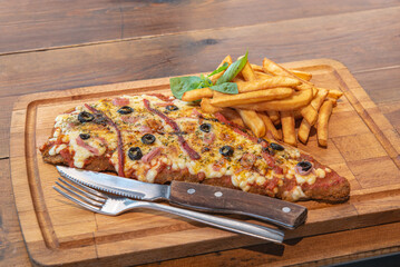Typical Neapolitan Milanese typical food from Argentina and Uruguay served with French fries and on...