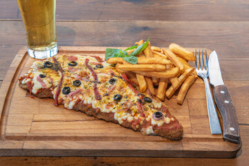Typical Neapolitan Milanese typical food from Argentina and Uruguay served with French fries and on...