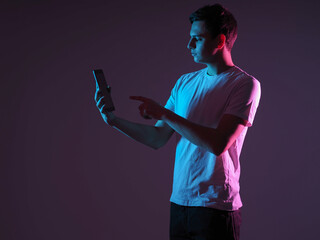 Man with a tablet. Gadget in guy hand. He pulls his finger towards screen. Tablet pc in student...