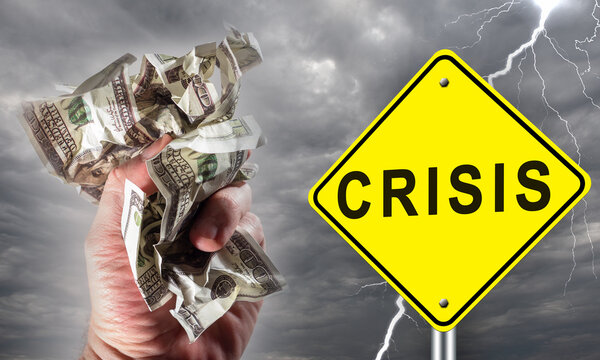 Financial crisis. Road sign with crisis logo on rainy sky background. Bad weather as symbol of impending problems. Man hand crumples money. Concept - imminent economic crisis. Recession approaching