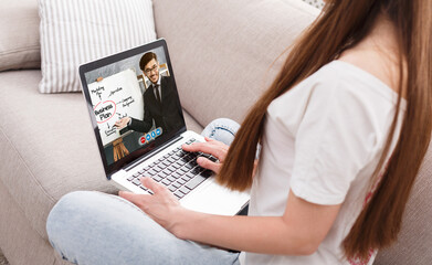 Unrecognizable woman having video conference with business coach while sitting at home