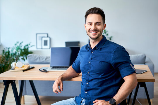 Portrait of confident young business man working at home