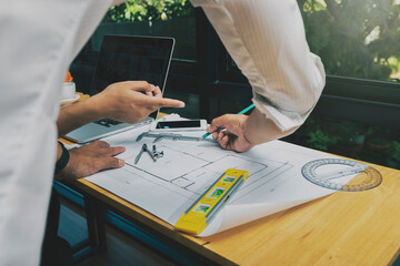 Confident team of architect working together in a office.They discussing about new startup project on desk. Architect discuss with engineer about project in office, architectural concept