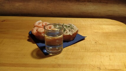 vodka and snack. glass of Russian vodka and fish food snack