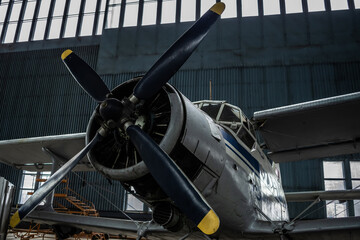 The biplane is in the hangar for maintenance. Selective focus.