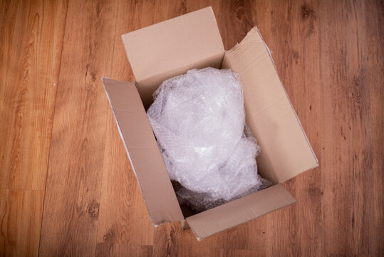 Open Box With Bubble Wrap On The Ground