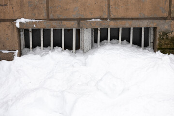 snow has littered the basement window in winter