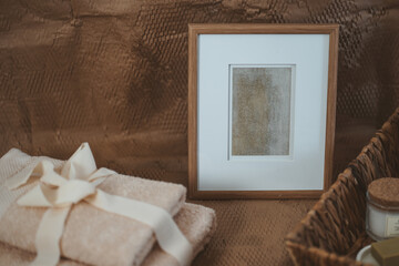 Wooden photo frame in the boho interior, next to the basket