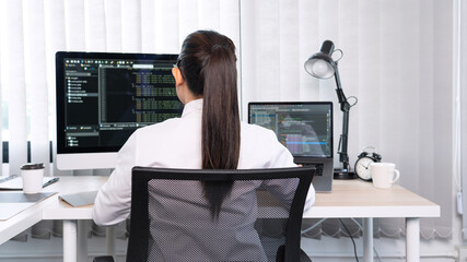 Asian Woman programmer typing source codes Programming On Computer in office, freelance web...