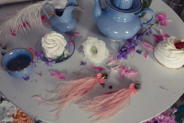 Vintage still life from the service, vintage jewelry and pink peonies.