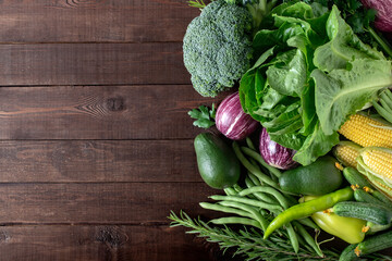 Fresh vegetables on a wooden background with copy space. Vegetarian concept.