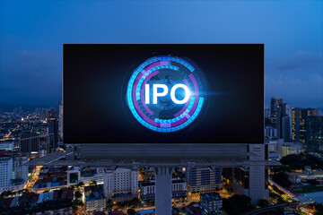 IPO icon hologram on road billboard over night panorama city view of Kuala Lumpur. KL is the hub of...
