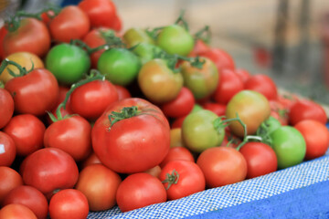 A pile of ready tomatoes for sale.