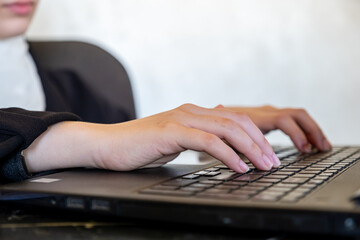 woman hands on laptop keyboard while typing