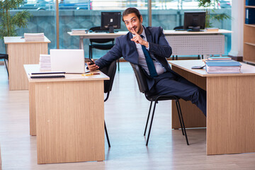 Young male employee working in the office