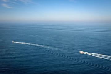 Boats sailing in the calm turquoise waters of the Mediterranean Sea in Cap Negre on a summer day with blue sky, Javea, Alicante, Spain