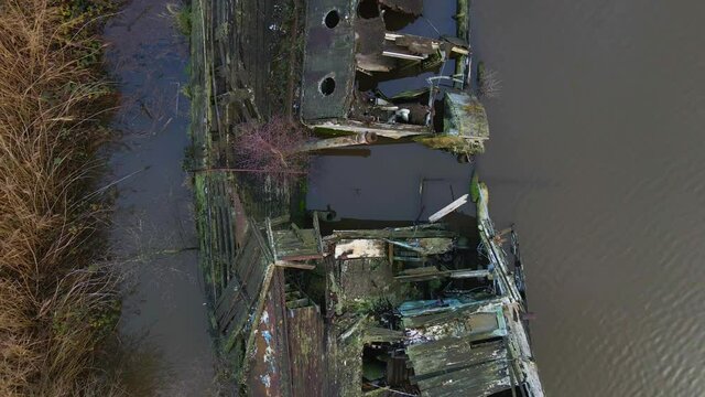 Flight above old half sunk boat in River Weaver near Northwich.  Derelict boat slowly rotting away between the locks and the Dutton Horse Bridge