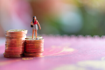 Miniature : woman standing on a coin Red background Financial concept
