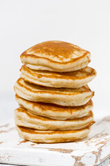 stack of delicious pancakes on a white background, vertical closeup