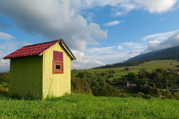 Fototapeta na wymiar Little green house in mountains