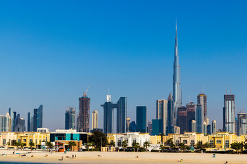 Fototapeta na wymiar Dubai, UAE - 02.27.2021 Dubai public beach with city skyline on background. Outdoors